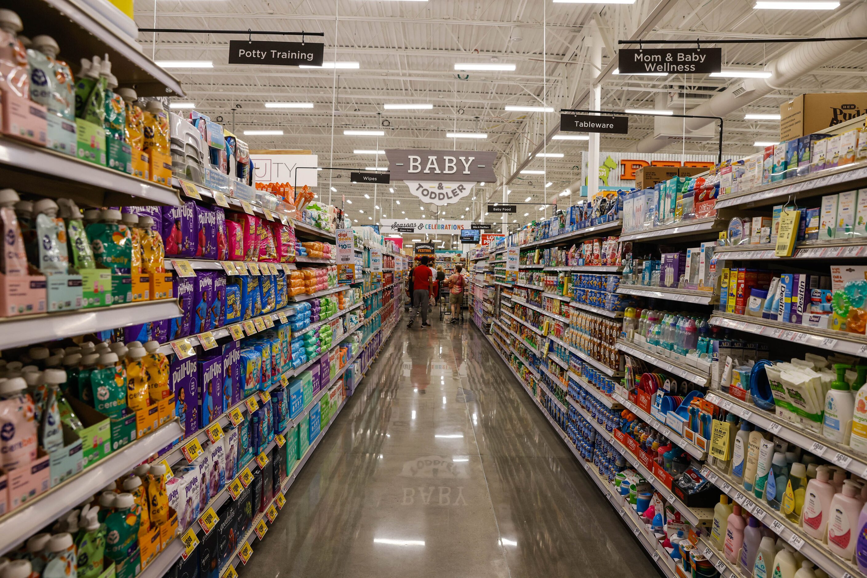 Customers do their regular grocery shopping at the new H-E-B store that opened its doors at...