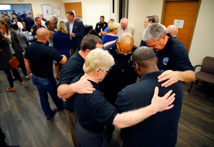 Fort Worth Police Chief Joel Fitzgerald (center, with glasses) joined members of the City of...