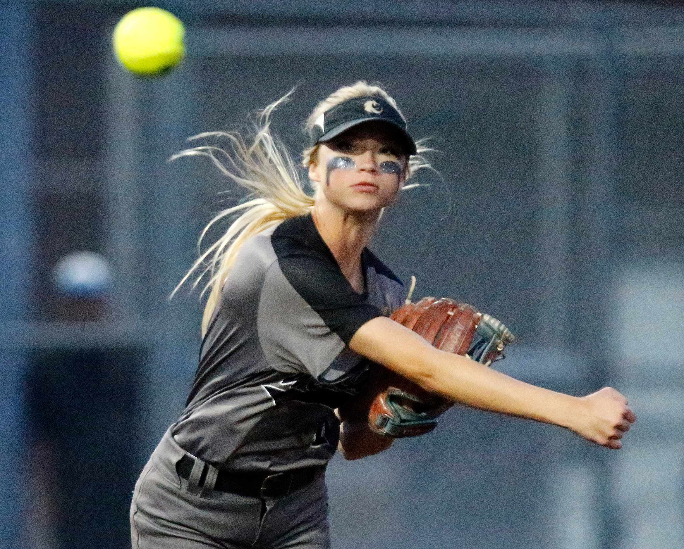 Denton Guyer High School third baseman Erin Peterson (4) throws for an out in the second...