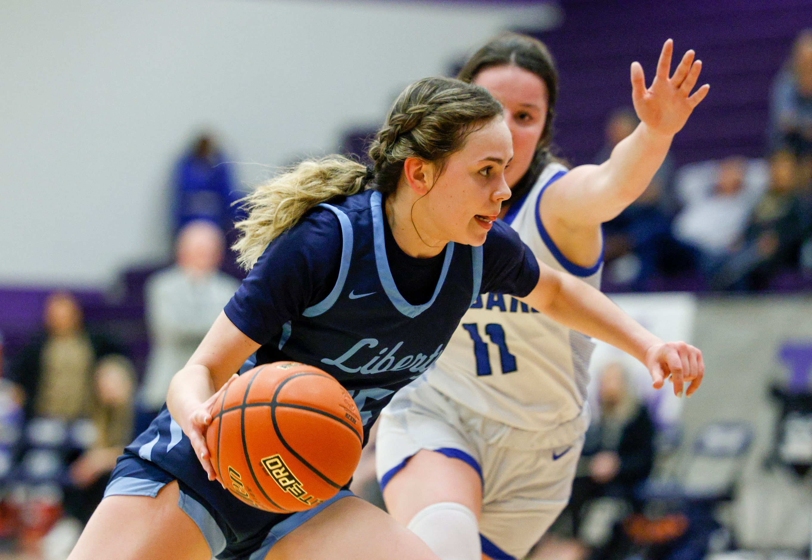 Argyle Liberty Christian guard Emma Martin (15) pushes the ball around Tyler Grace Community...