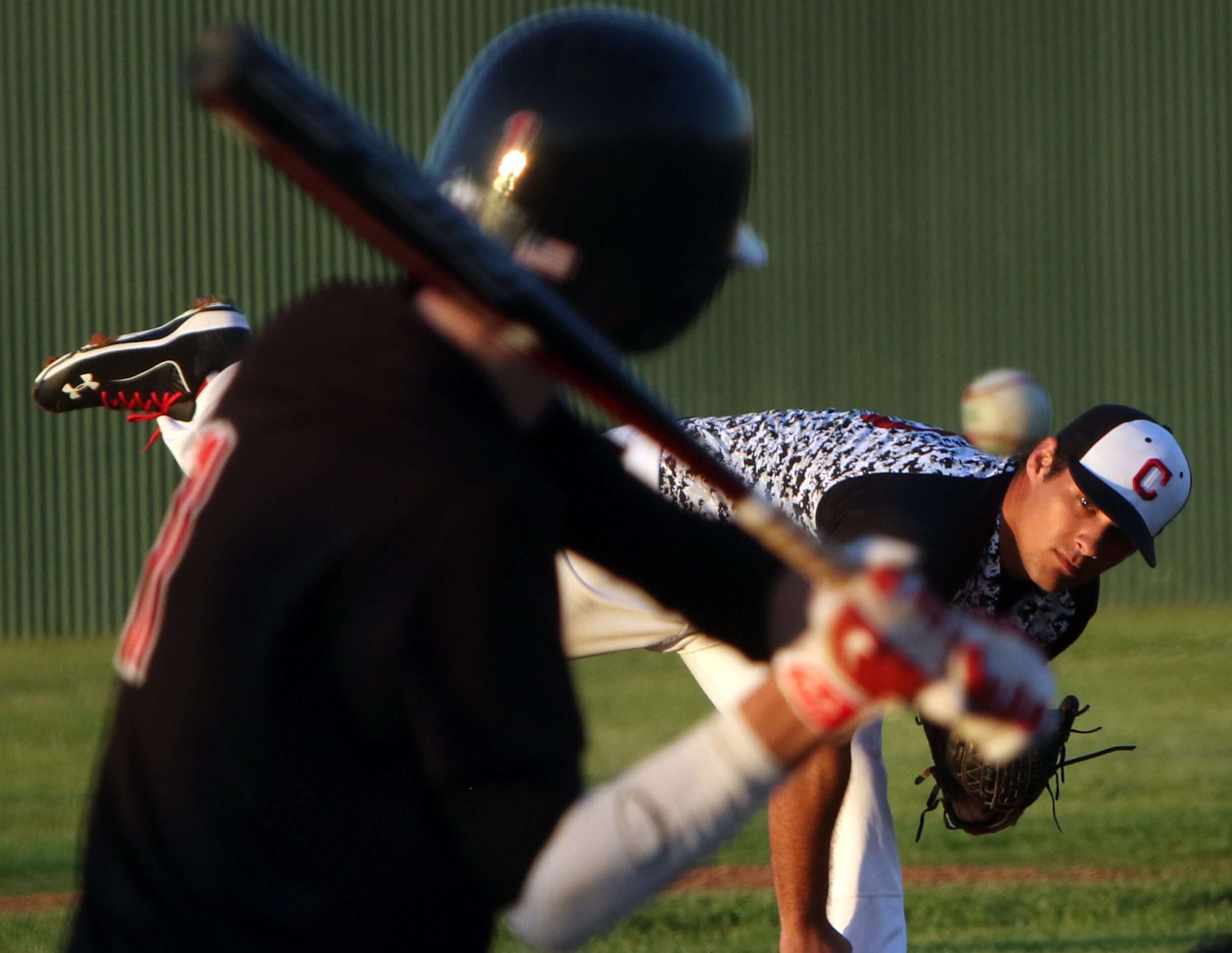 Carrollton Creekview pitcher Brandon White (15) hurls a fastball toward a Dallas Hillcrest...