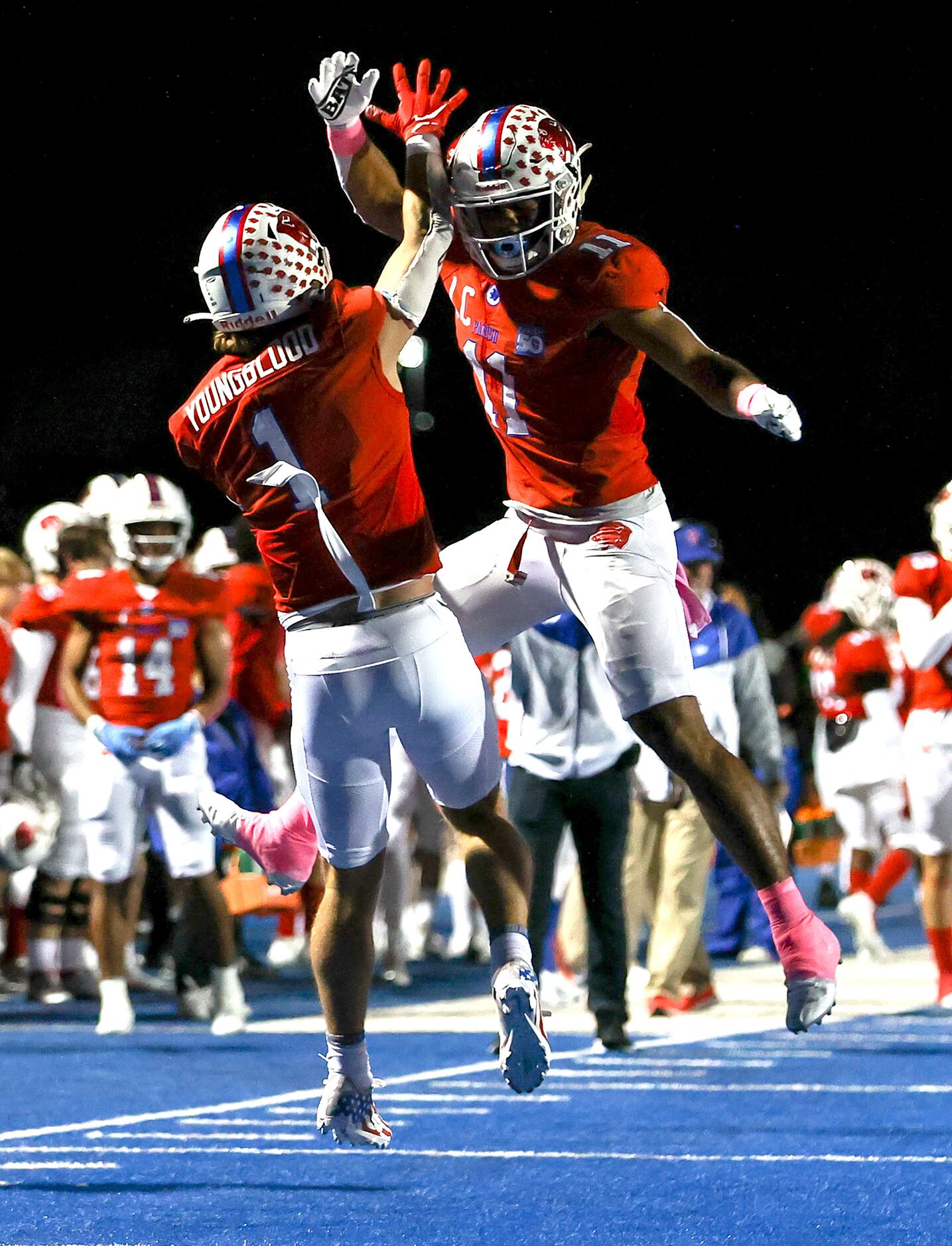 Parish wide receiver Blake Youngblood (1) celebrates with teammate Noah Billings (11) after...