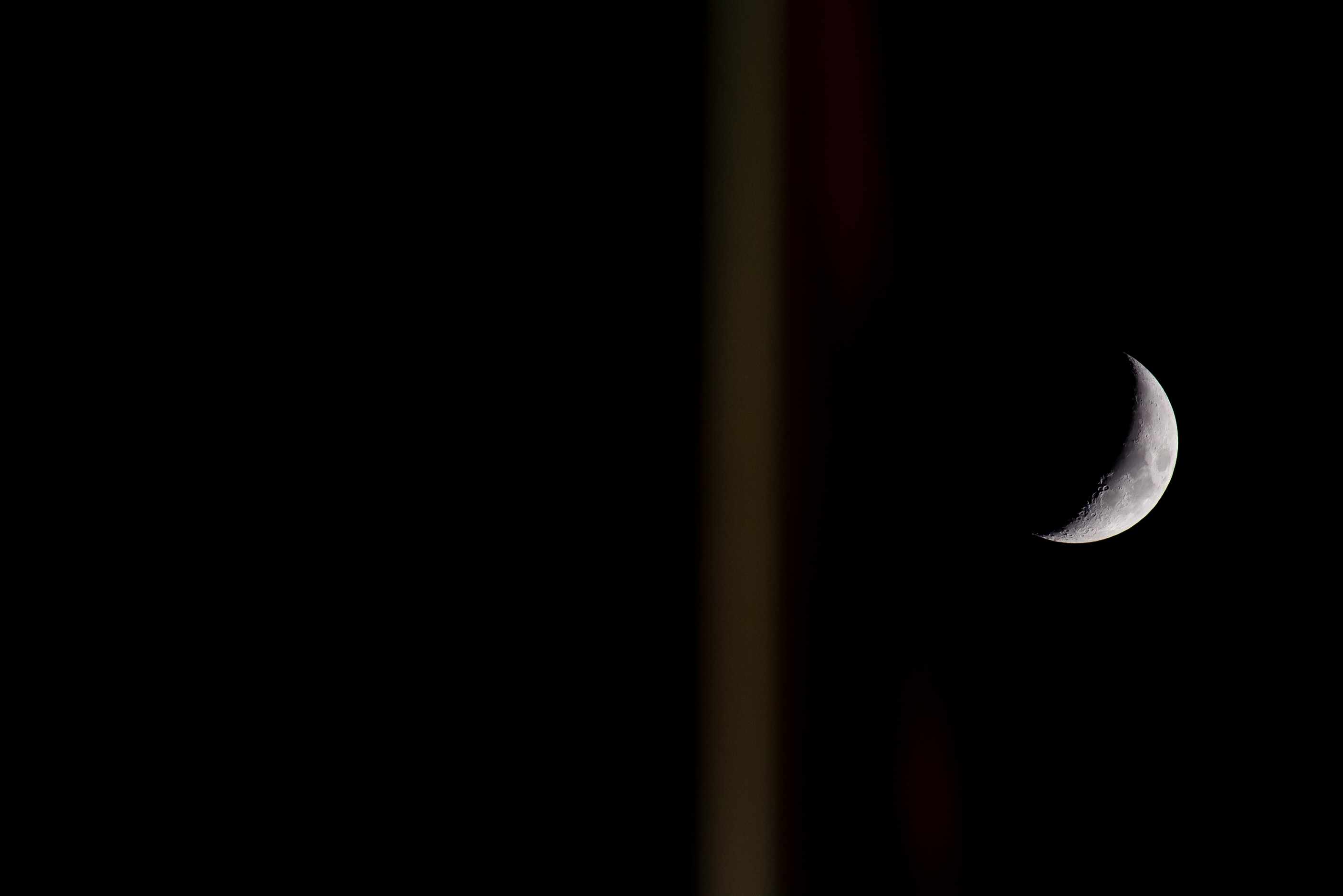 The moon rises behind a goal post during a District 4-5A Division II game between Grapevine...