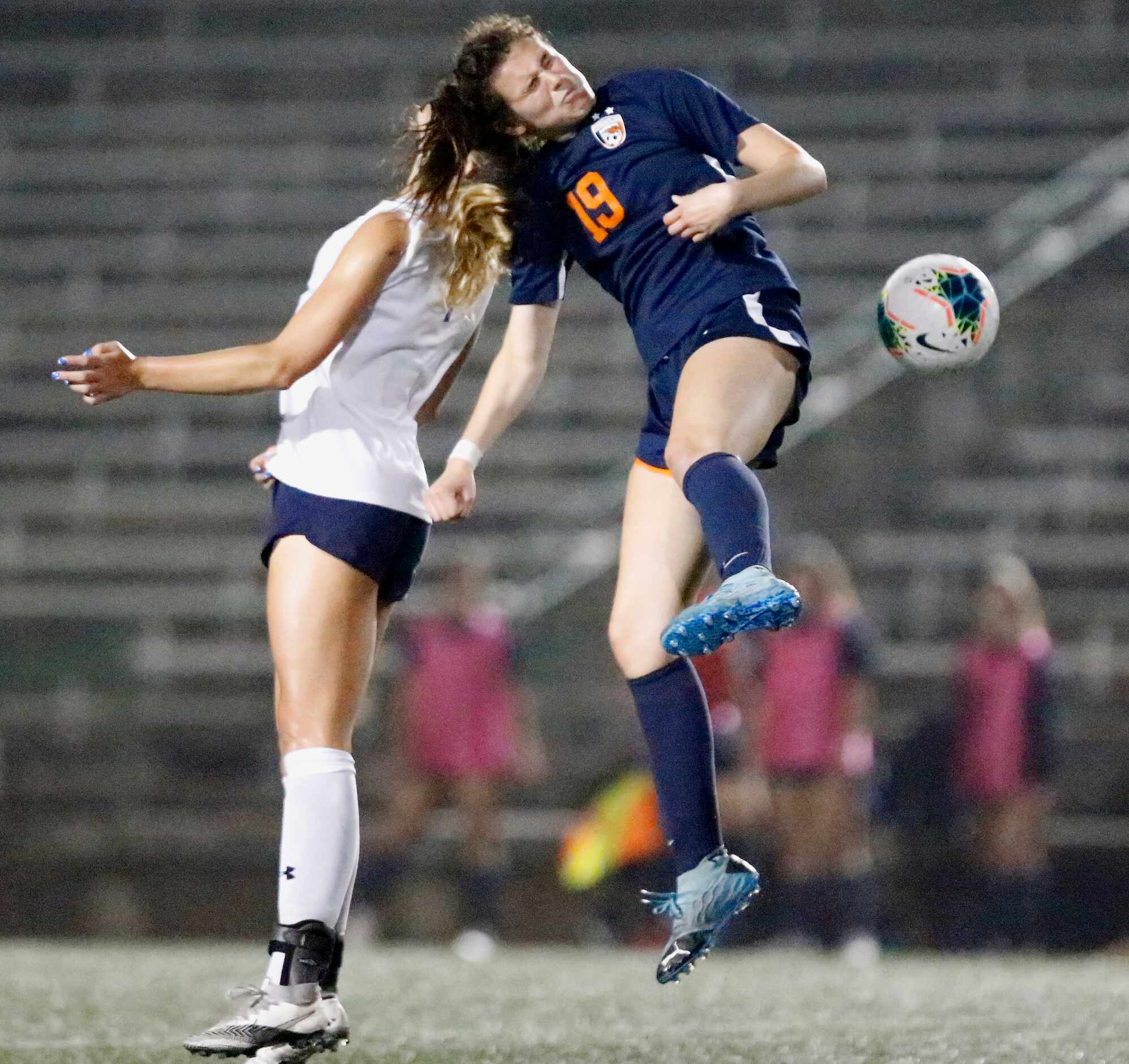 Highland Park midfielder EmJ Cox (7) goes up for a header with Wakeland midfielder Faith...