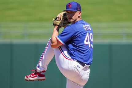 Texas Rangers pitcher Glenn Otto delivers during the first inning of a spring training game...