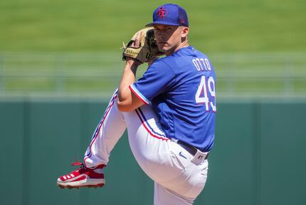 Texas Rangers pitcher Glenn Otto delivers during the first inning of a spring training game...