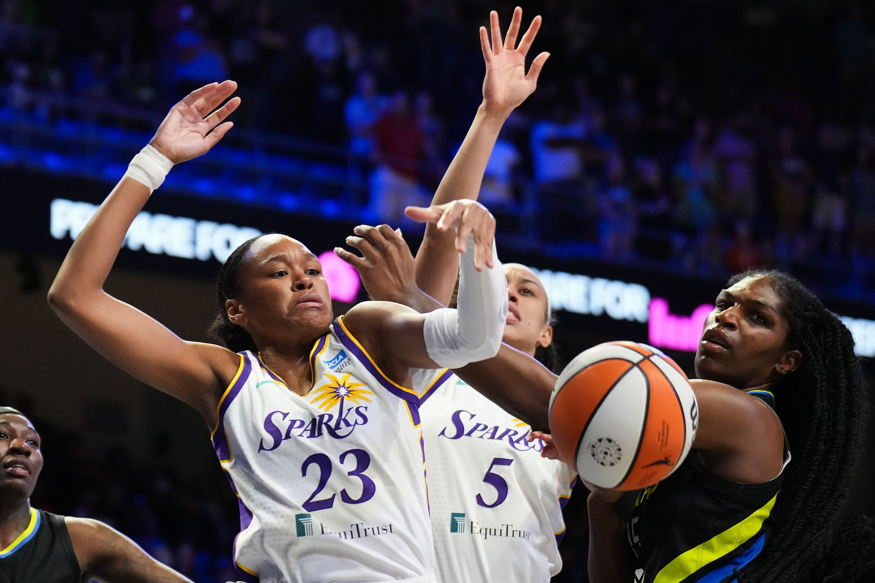 Dallas Wings center Teaira McCowan (15) fights for a rebound with Los Angeles Sparks forward...