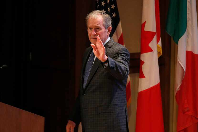 Former President George W. Bush waves after speaking during the 2016 North American Strategy...