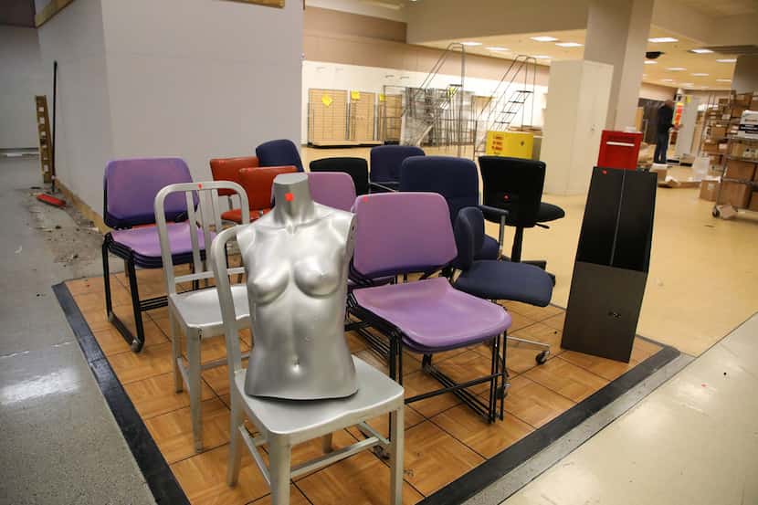 Part of a mannequin can be seen on a chair inside the soon-to-be closed Sears store at...