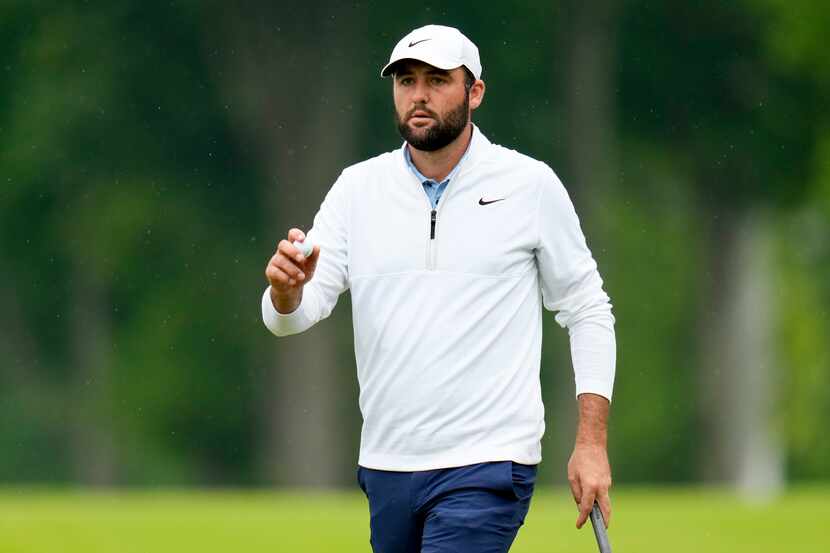 Scottie Scheffler celebrates after a birdie on the 10th hole during the second round of the...