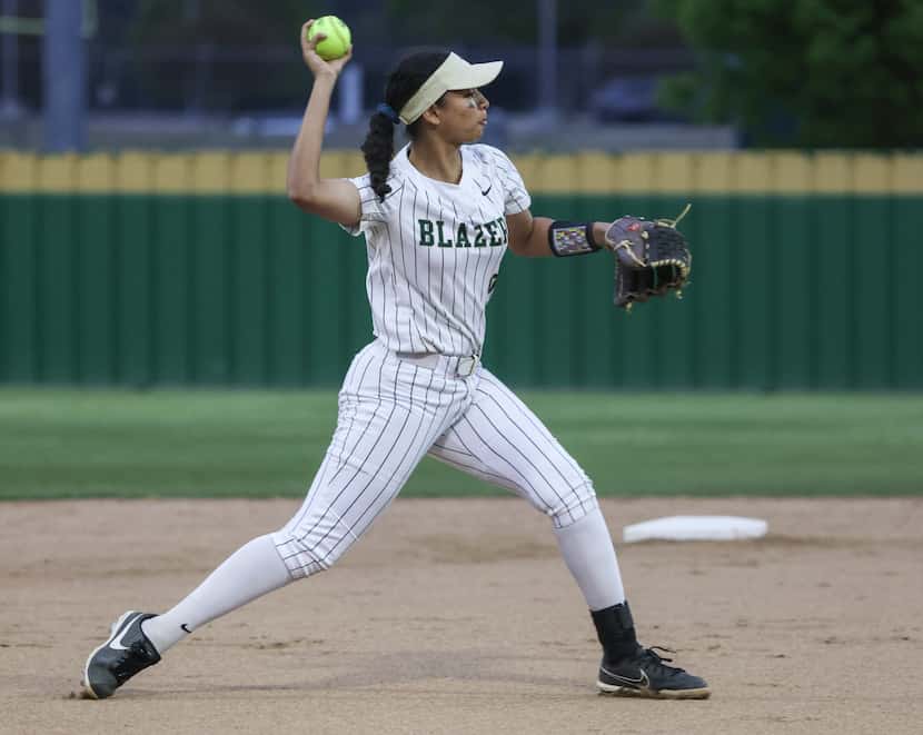 Frisco Lebanon Trail High School shortstop, Snigdha Paul, throws the ball to first base...