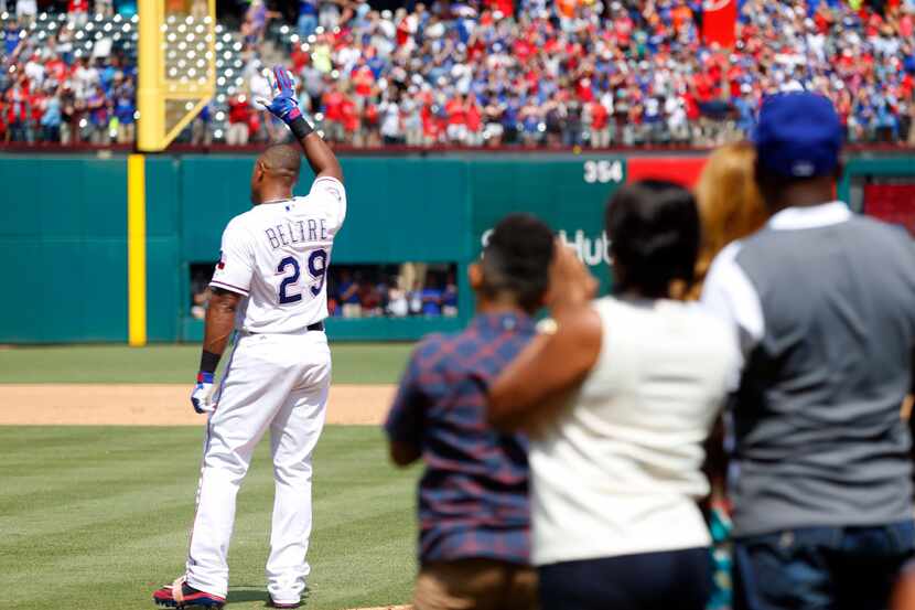 Texas Rangers Adrian Beltre (29) waves to the crowd as his family looks on after hitting his...