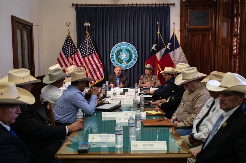 Gov. Greg Abbott, shown with border community sheriffs at the Texas Capitol on July 10, was...