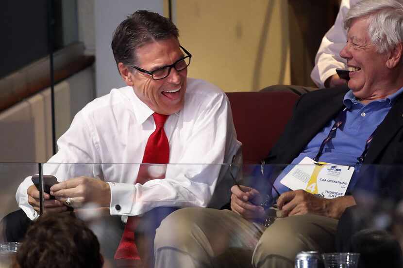 Former Texas Gov. Rick Perry watches from a suite on the final day of the Republican...