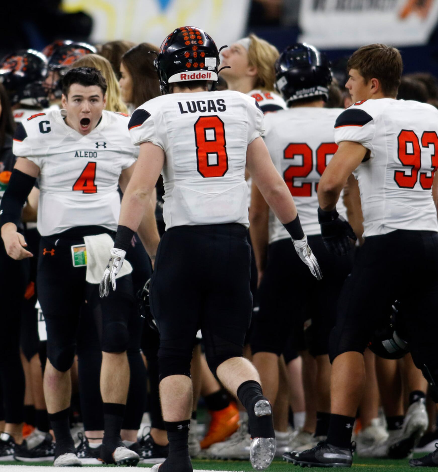 Aledo quarterback Jake Bishop (4) lets out a yell on the team sideline after throwing his...