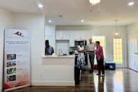 Community members tour a new home during a ribbon-cutting ceremony in the Five Mile...
