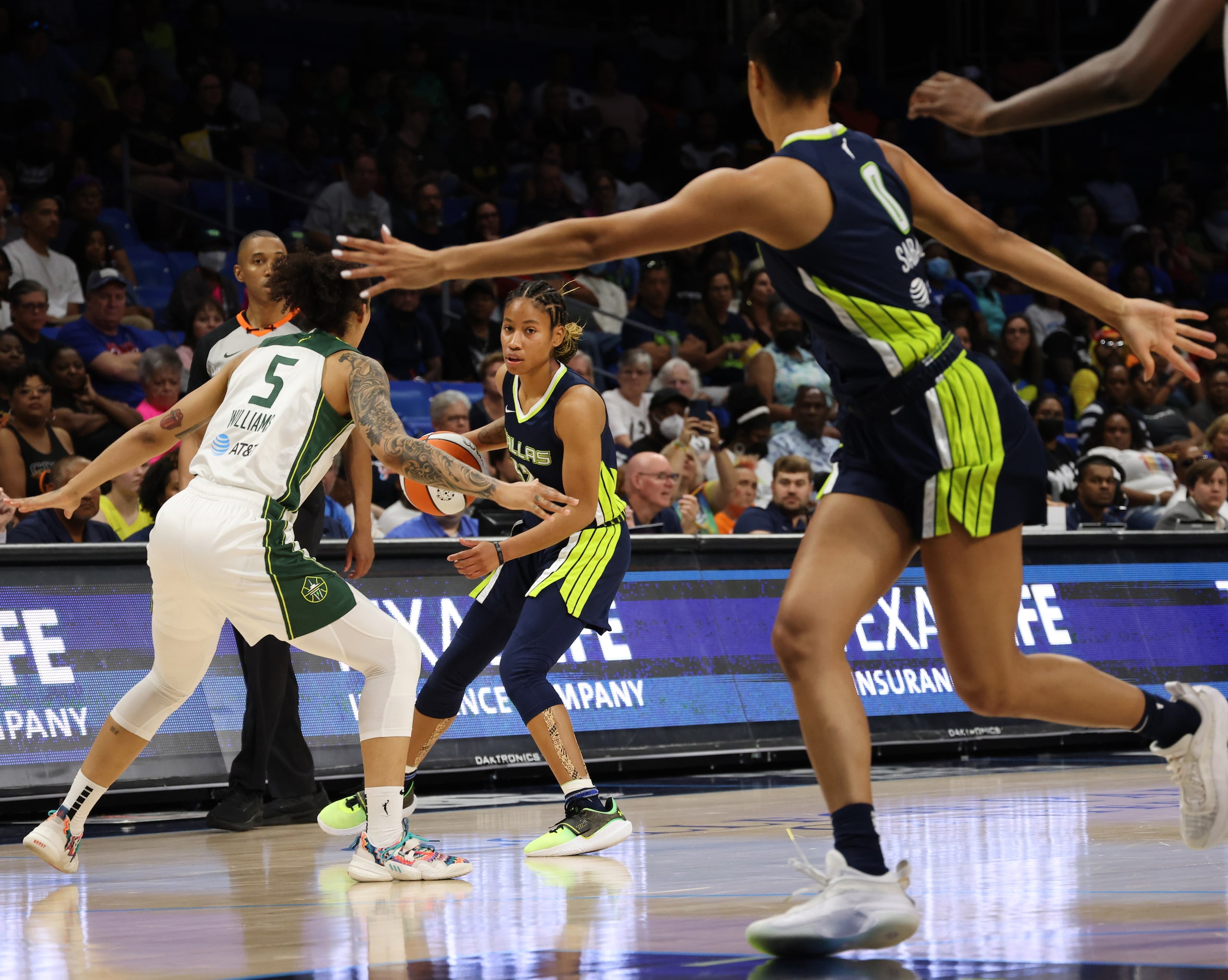 Dallas Wings guard Tyasha Harris (52) looks to pass to forward Satou Sabally (0) as she is...