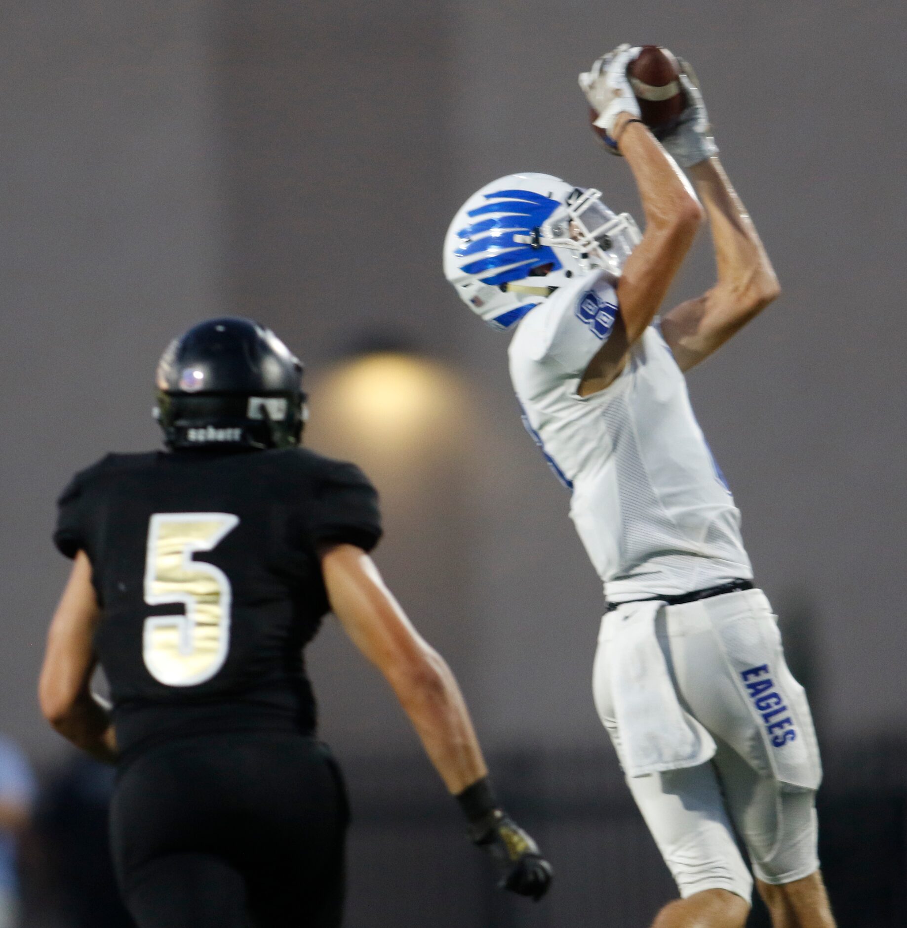 Lindale receiver Evan Alford (8) pulls in a long pass as Kaufman linebacker Mason Ashton (5)...