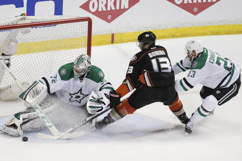 Dallas Stars' Kari Lehtonen, left, of Finland, stops a shot by Anaheim Ducks' Nick Bonino,...