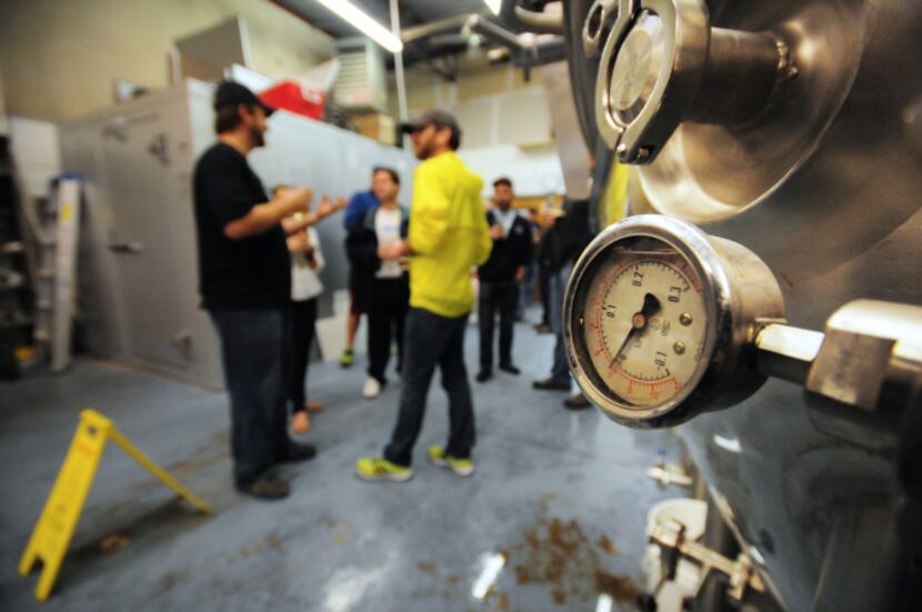 FireWheel Brewing Company owner Brad Perkinson takes a group of visitors through the tour.