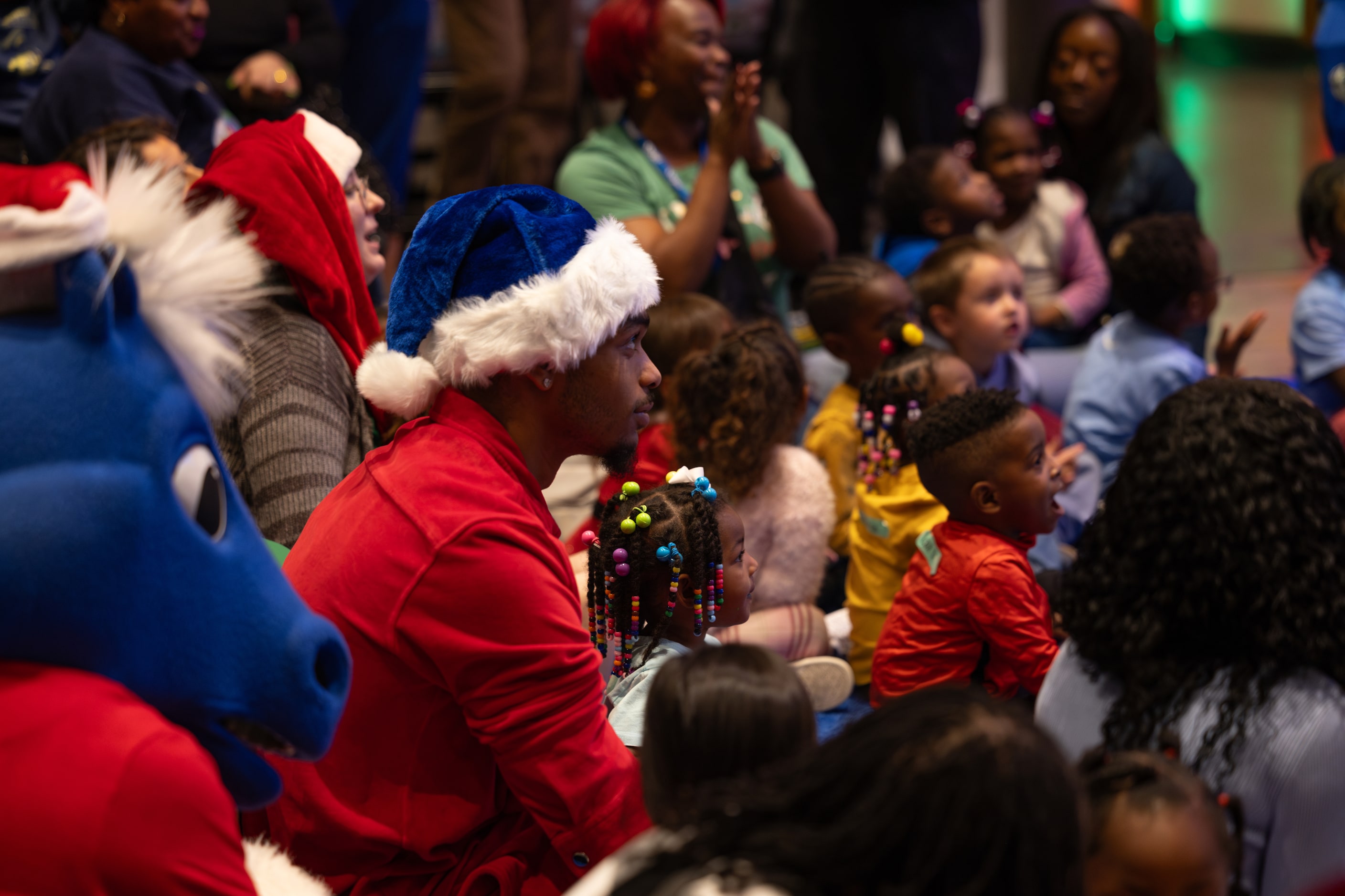 Mavericks forward  P.J. Washington listens with kids as Olivier-Maxence Prosper reads “’Twas...