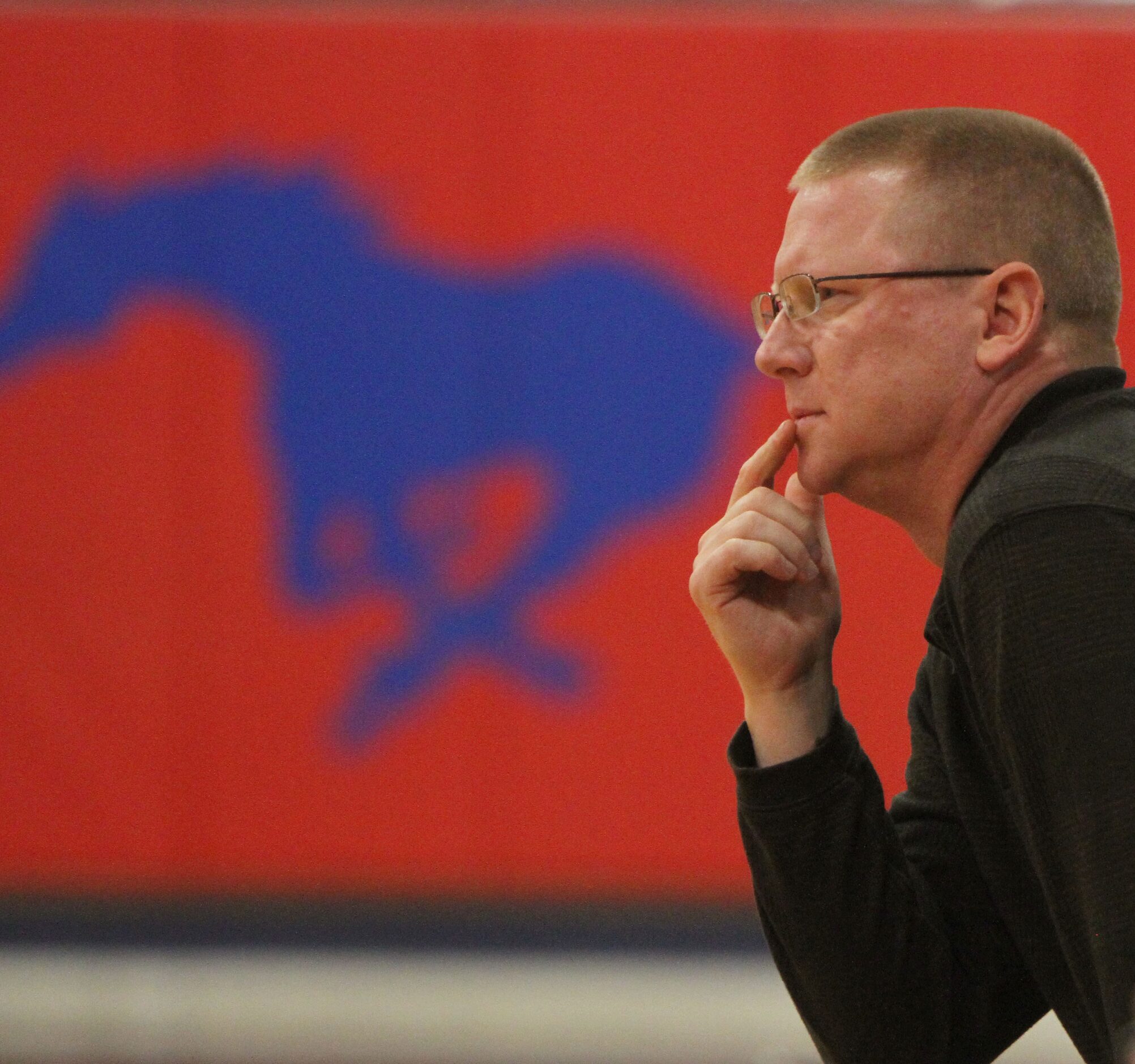 Frisco Centennial head coach Mike Scarbrough takes in second half action of their game...