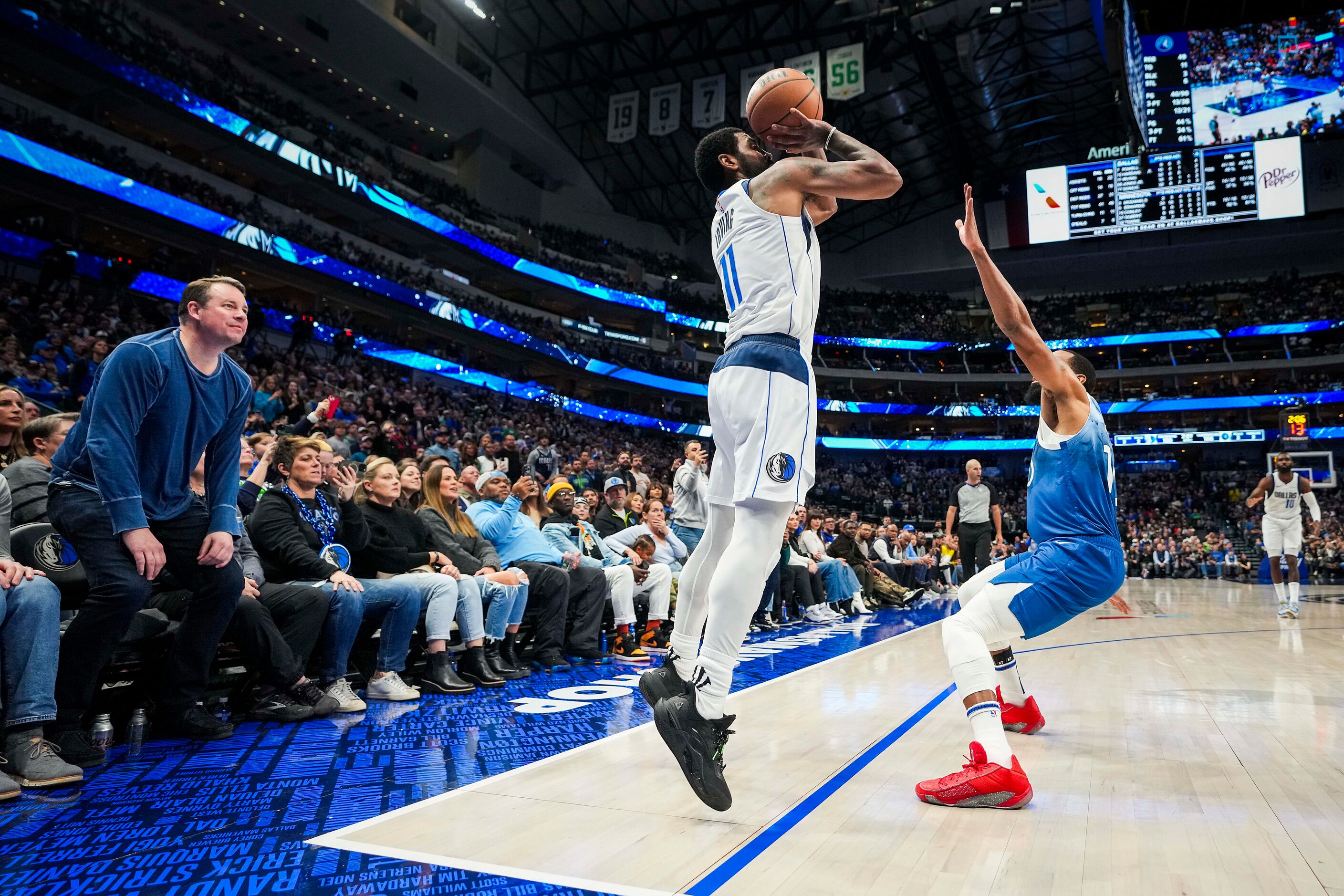 Dallas Mavericks guard Kyrie Irving (11) hits a corner-three over Minnesota Timberwolves...