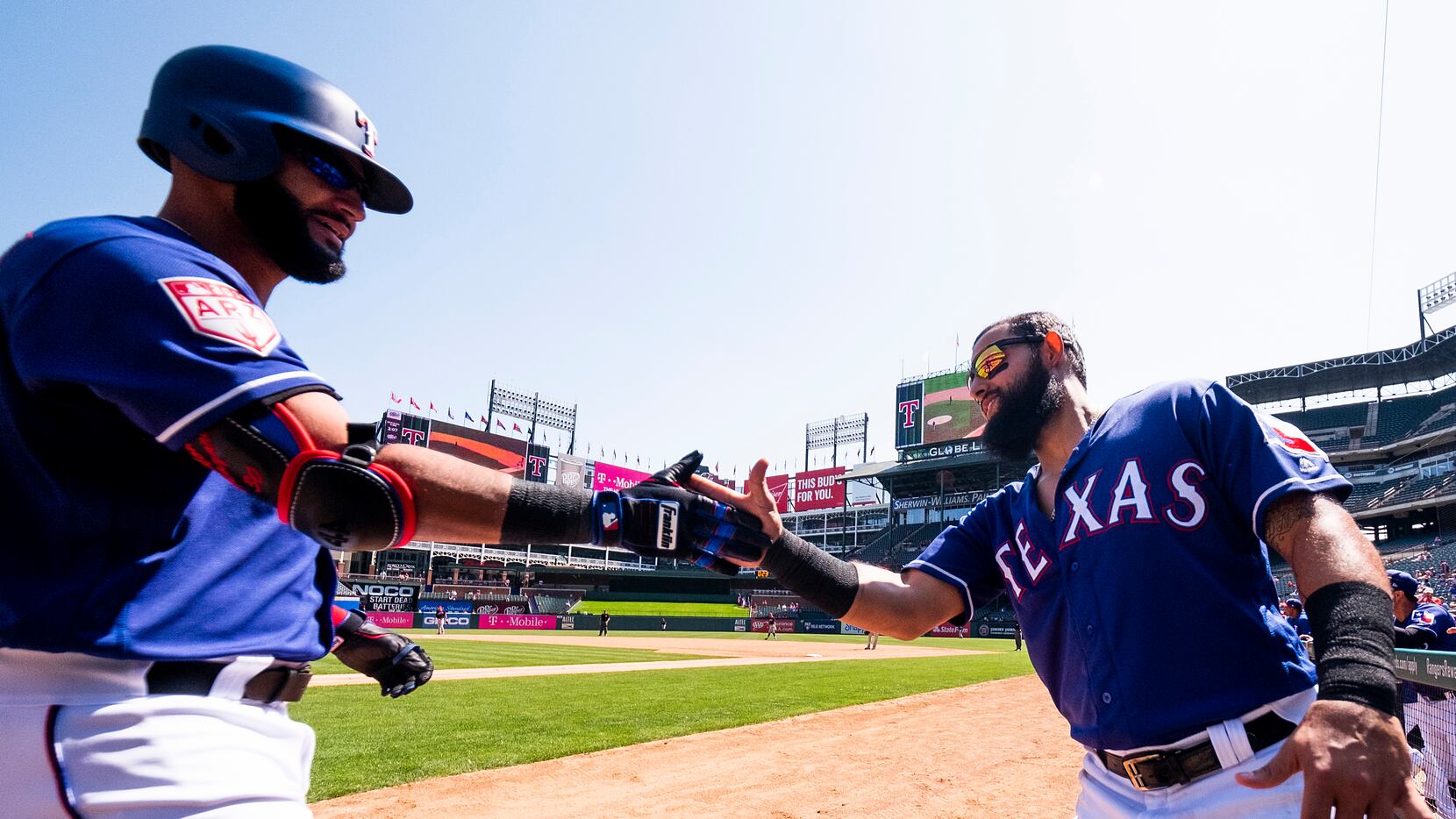 Texas Rangers outfielder Nomar Mazara (left) celebrates with second baseman Rougned Odor...