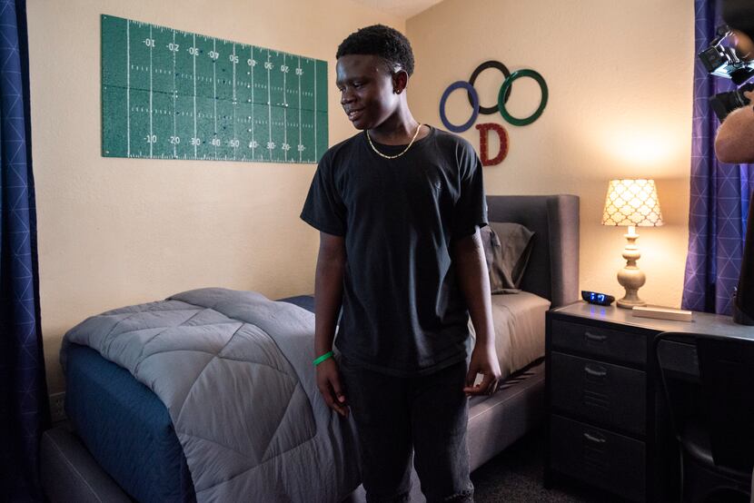 Daniel Bobb, 13, reacts with a smile as he sees his newly decorated bedroom in Garland. The...