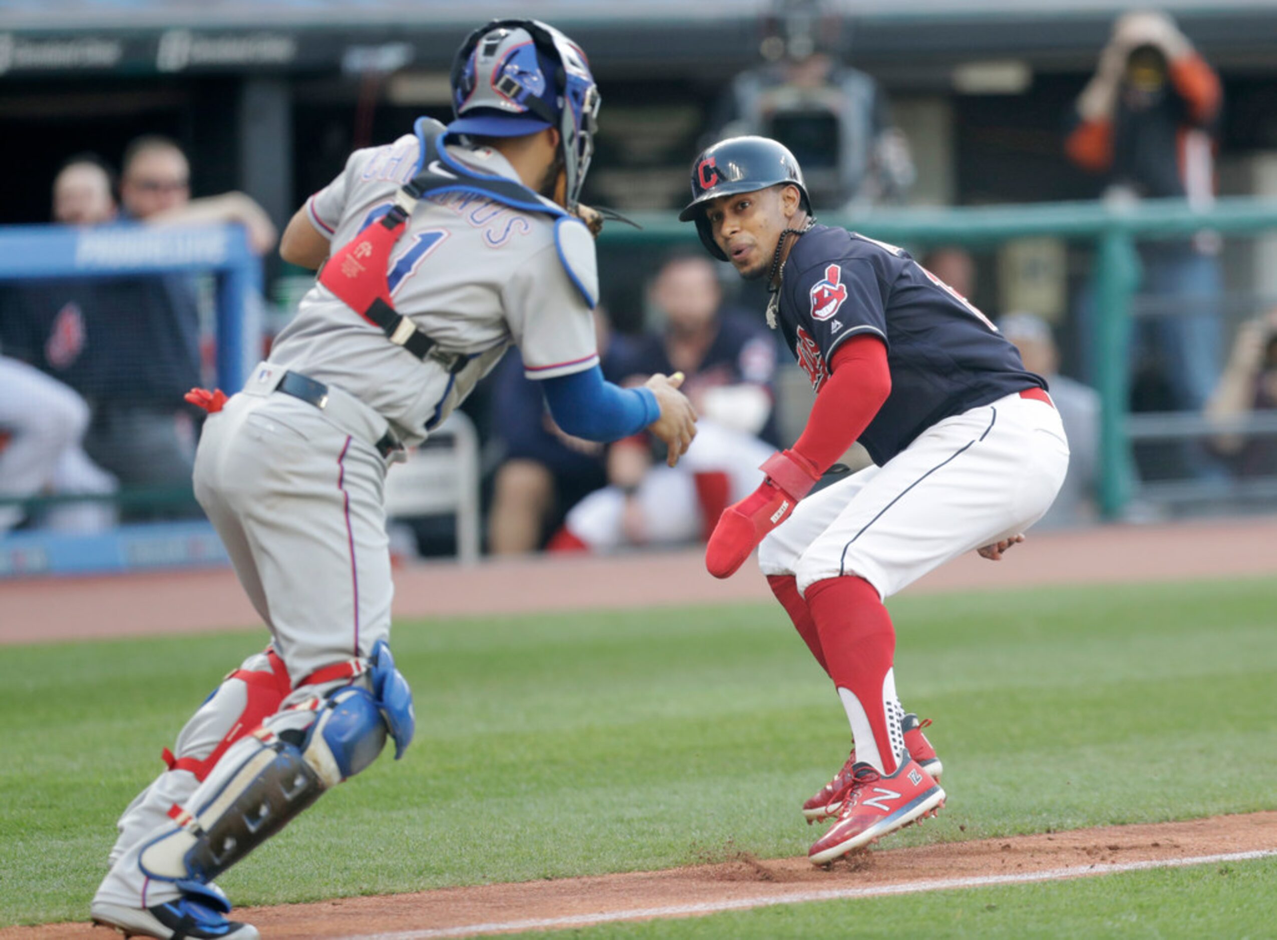 Cleveland Indians' Francisco Lindor looks back as Texas Rangers catcher Robinson Chirinos...