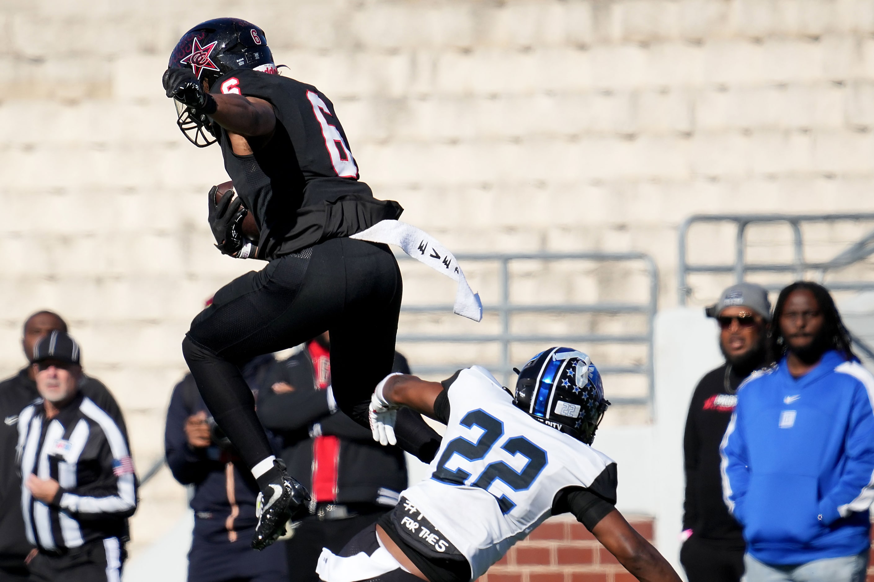 Coppell running back O'Marion Mbakwe (6) hurdles North Crowley defensive back Gaylon McNeal...