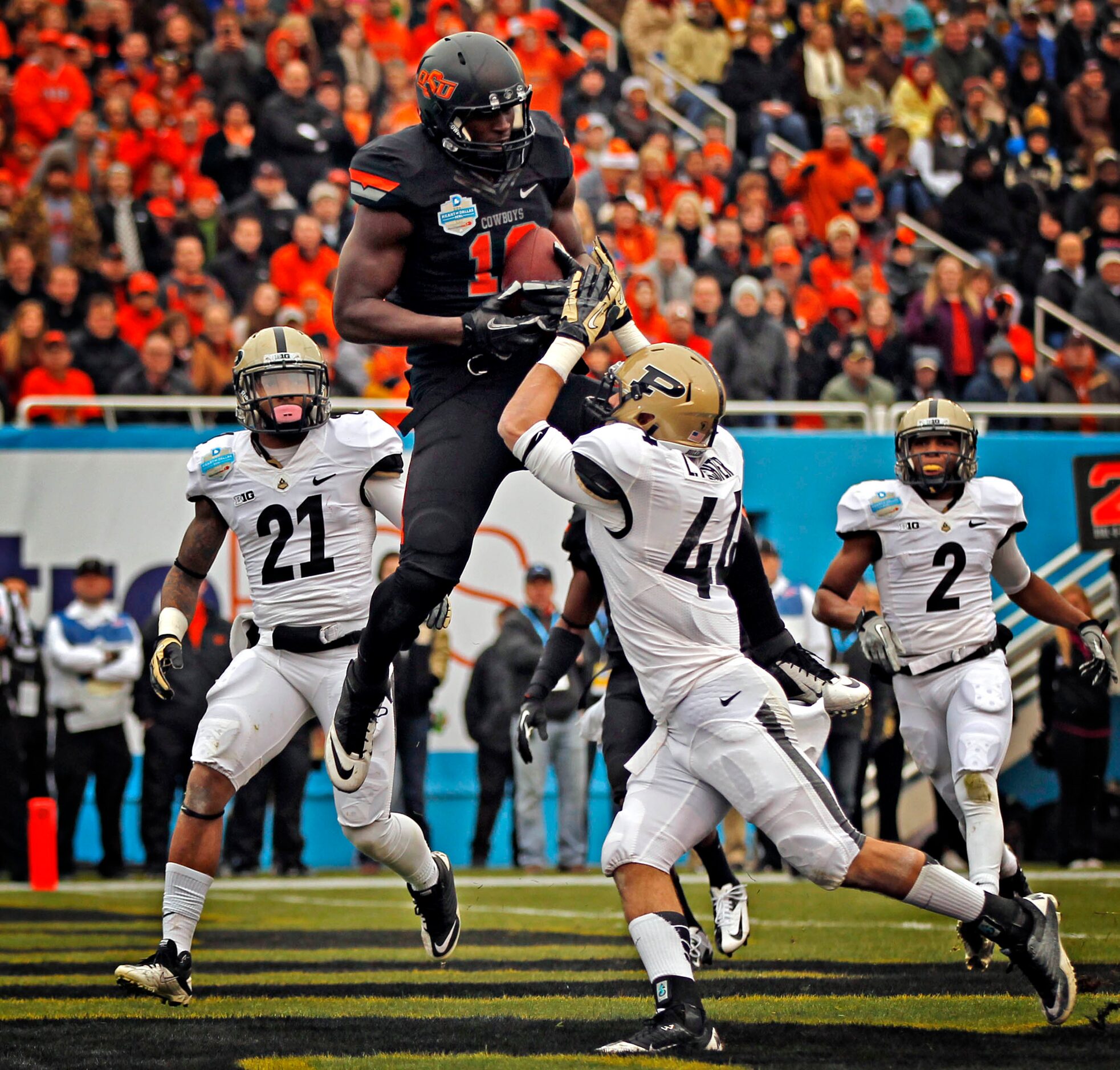 Oklahoma State Cowboys tight end Blake Jackson (18) gets above Purdue Boilermakers safety...