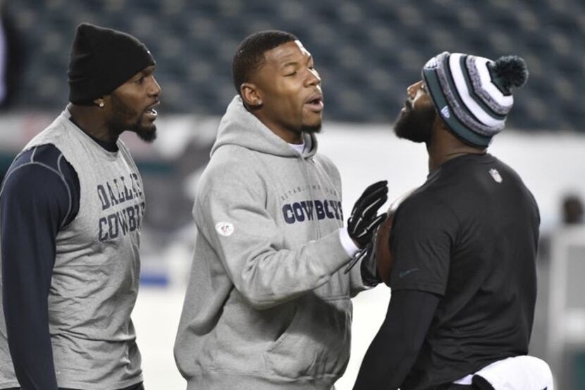 Dallas Cowboys wide receiver Terrance Williams, center, keeps the peace between wide...