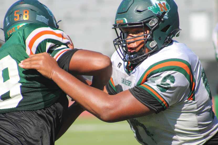 Garland Naaman Forest defensive lineman Markis Deal blocks a defender in a pass rushing...