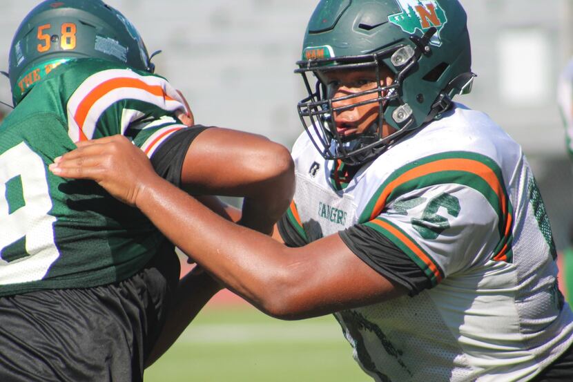 Garland Naaman Forest defensive lineman Markis Deal blocks a defender in a pass rushing...