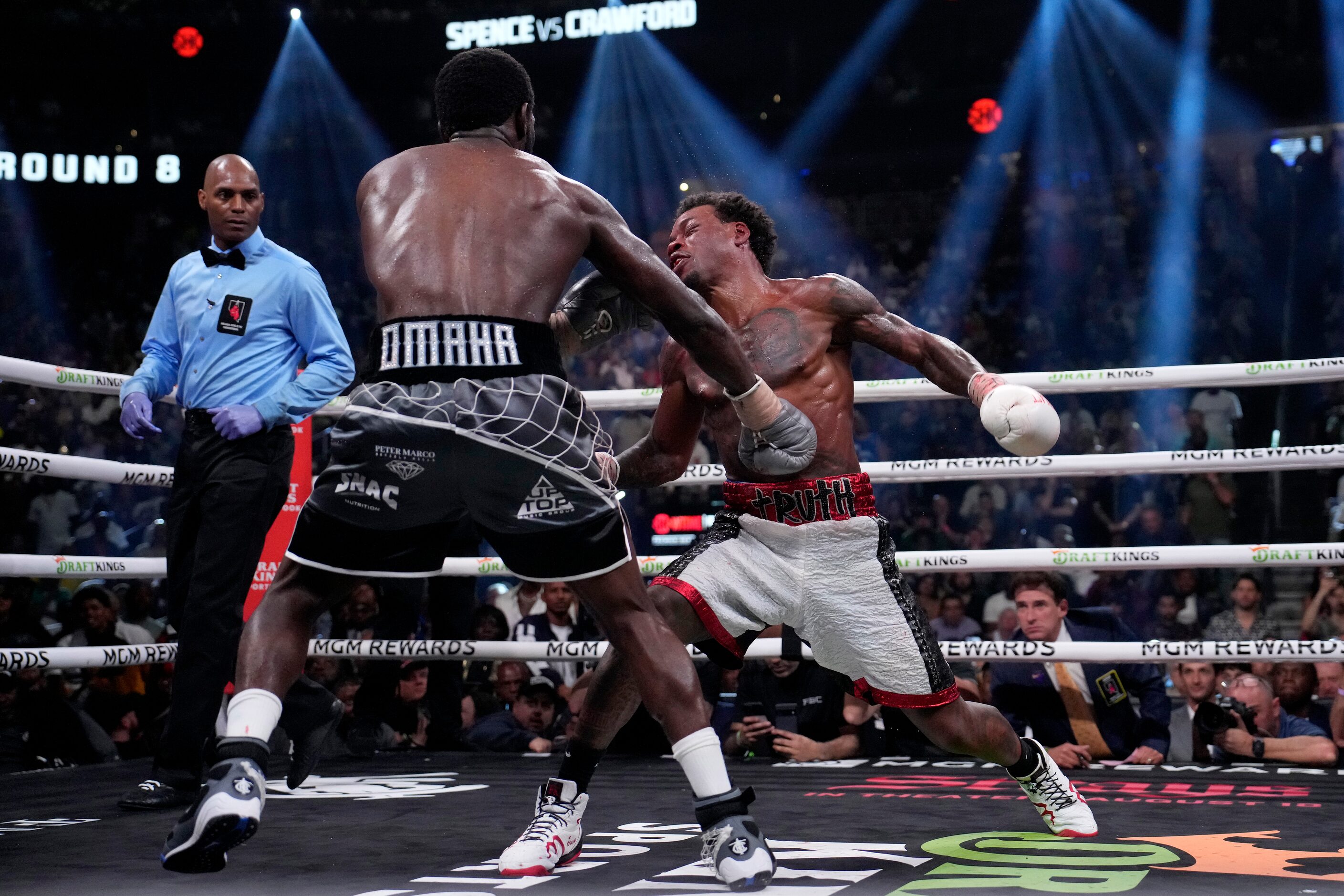 Terence Crawford, left, knocks down Errol Spence Jr. fight during their undisputed...