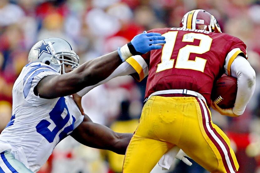 Dallas Cowboys defensive end DeMarcus Ware (94) tries to bring down Washington Redskins...