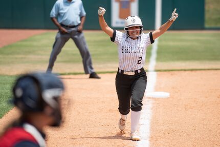 Bishop Lynch senior Natalie Escalante (2) cheers as she runs home to score a run during the...