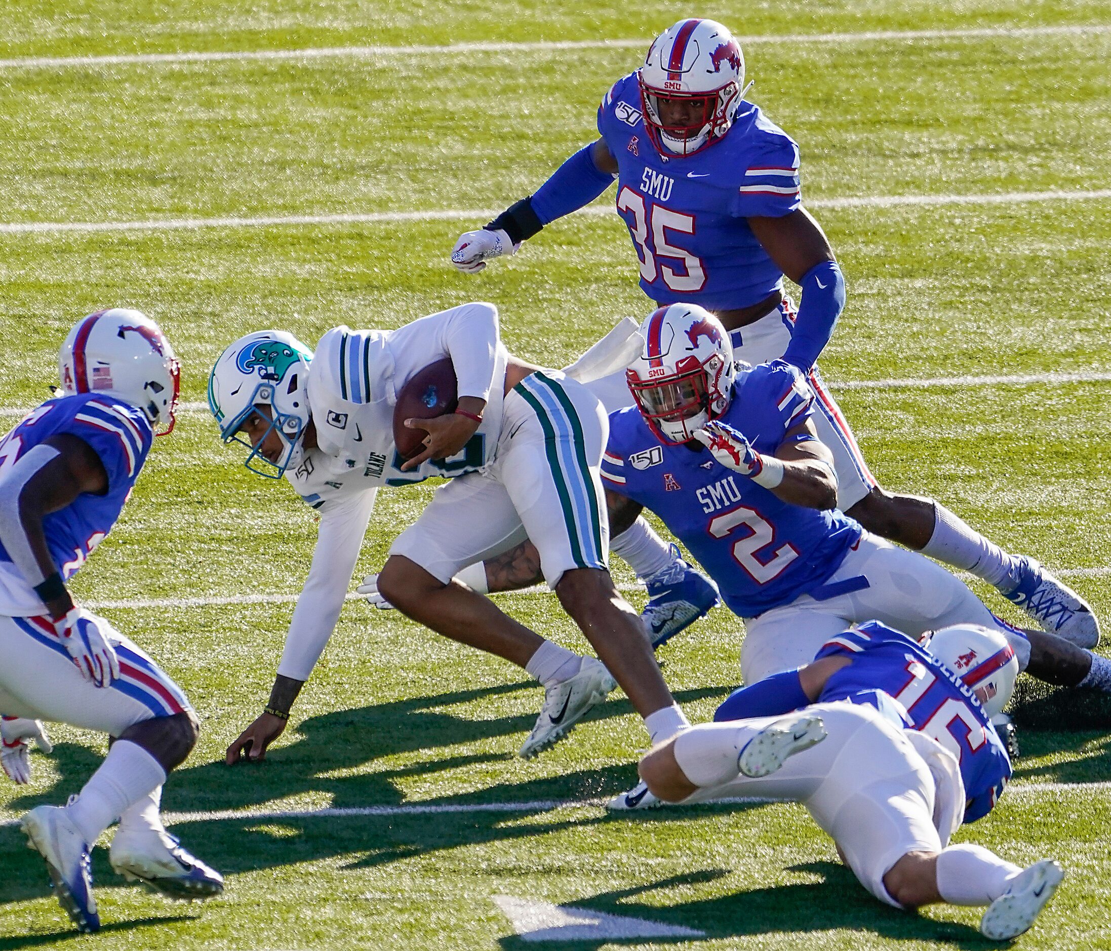 Tulane quarterback Justin McMillan (12) is brought down by SMU defensive end Delontae Scott...