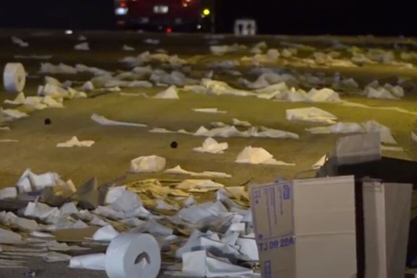 Toilet paper lies along Interstate 20 in Hutchins after an 18-wheeler crashed Wednesday...