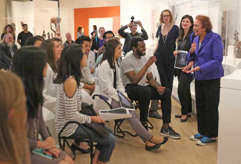 Bonnie Pitman talks with UT Southwestern Medical School students about items at the Dallas...