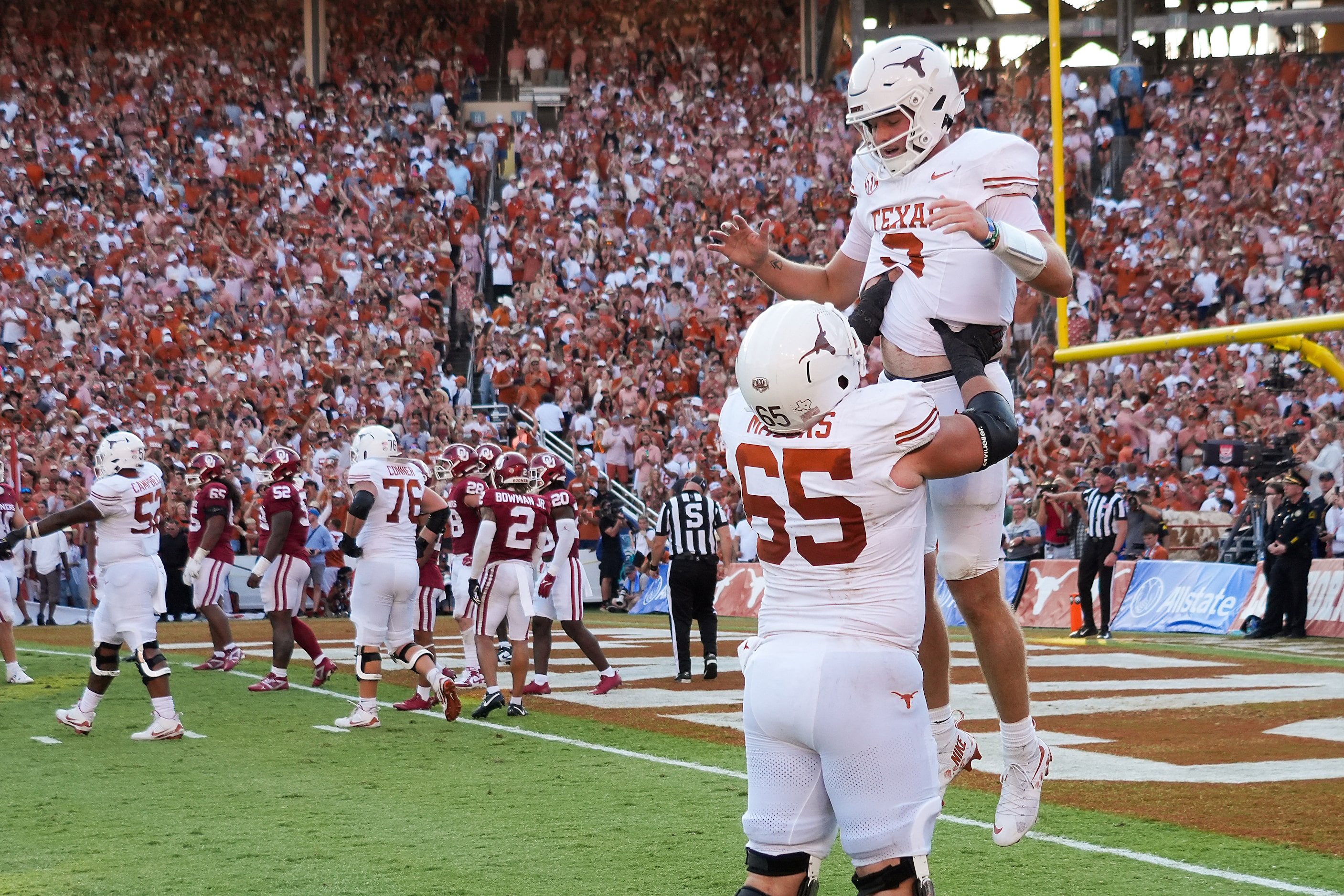 Texas quarterback Quinn Ewers (3) celebrates with offensive lineman Jake Majors (65) after...