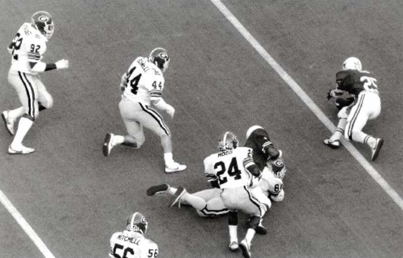 1984 --- With 4:32 left in the Cotton Bowl, Jitter Fields of the Longhorns tries to pick up...