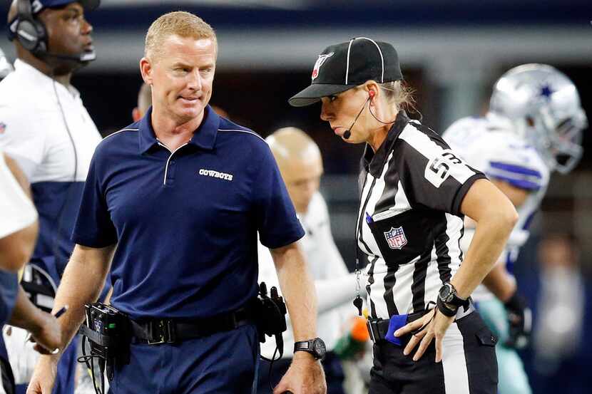 Dallas Cowboys head coach Jason Garrett explains himself to line judge Sarah Thomas (53)...