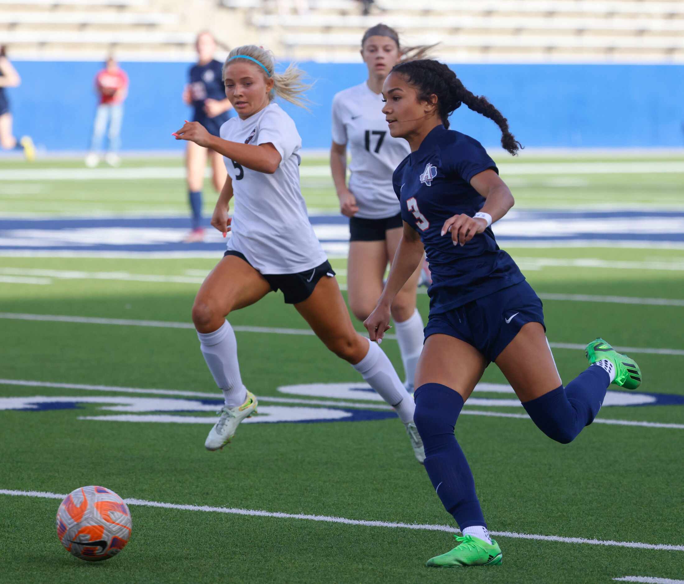 Allen’s Ava McDonald (right) runs past Marcus’ Savannah Wylie during the first half of a...