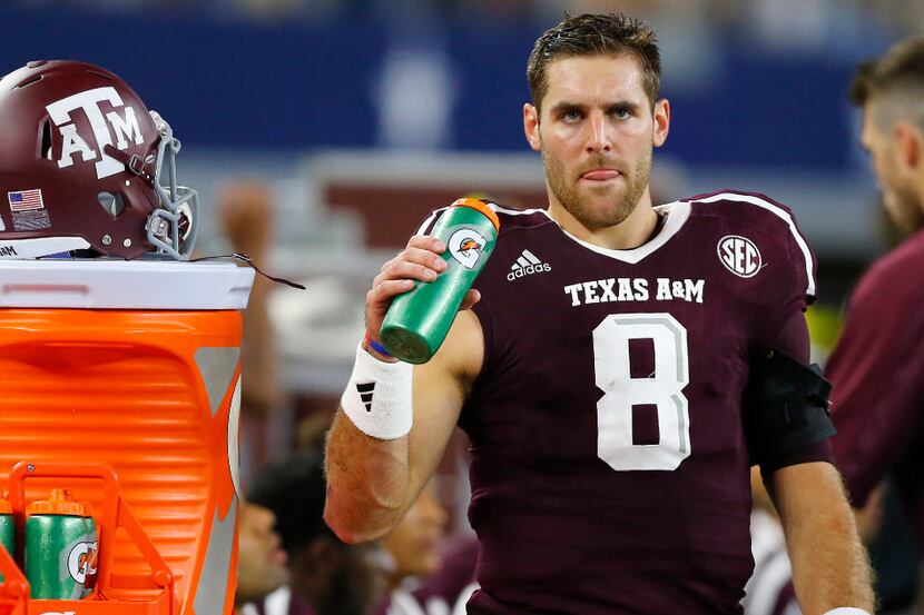 Texas A&M Aggies quarterback Trevor Knight (8) finds a drink of water on the sidelines in...