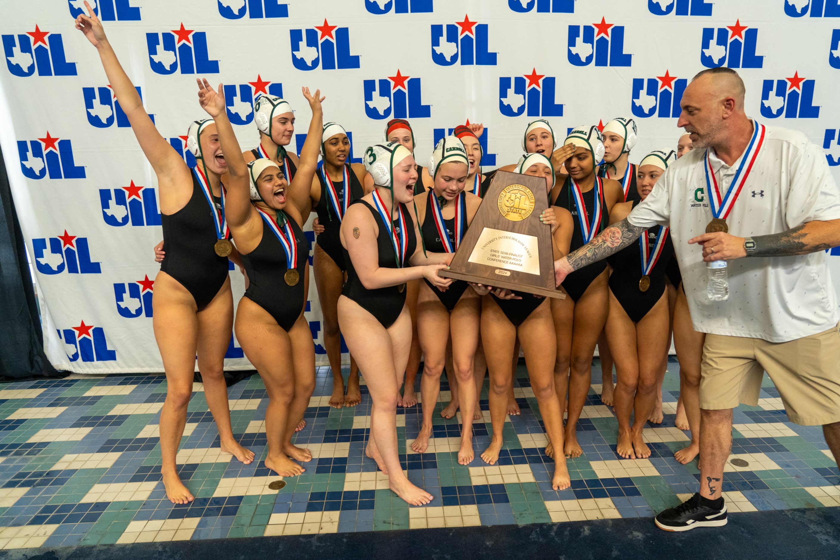 Southlake Carroll Dragons girls water polo coach Justin Pudwill presents the third-place...