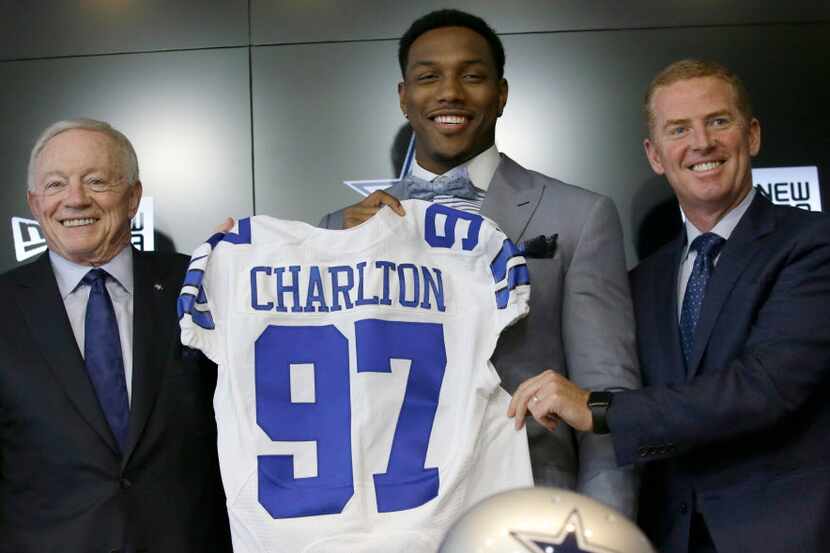 The Dallas Cowboys No. 1 draft pick defensive end Taco Charlton, center, poses for a photos...