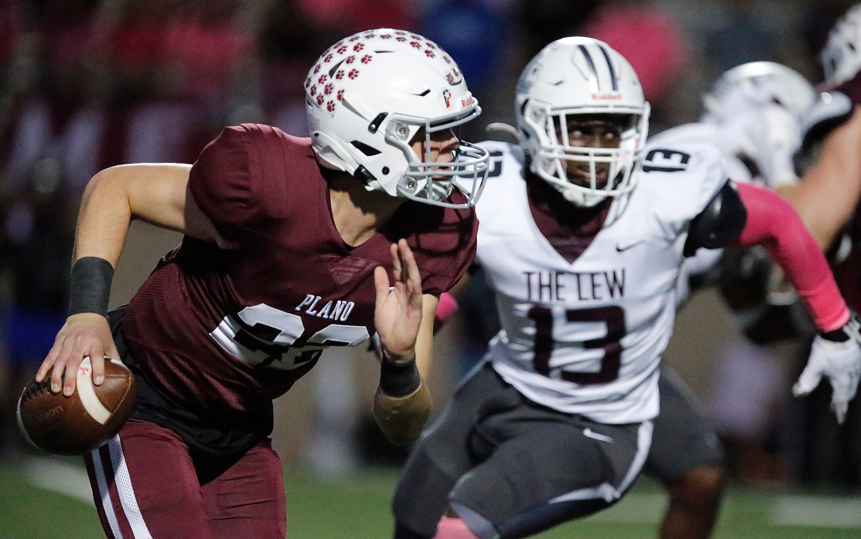 Plano Senior High School quarterback Drew Forkner (22) is pressured by Lewisville High...