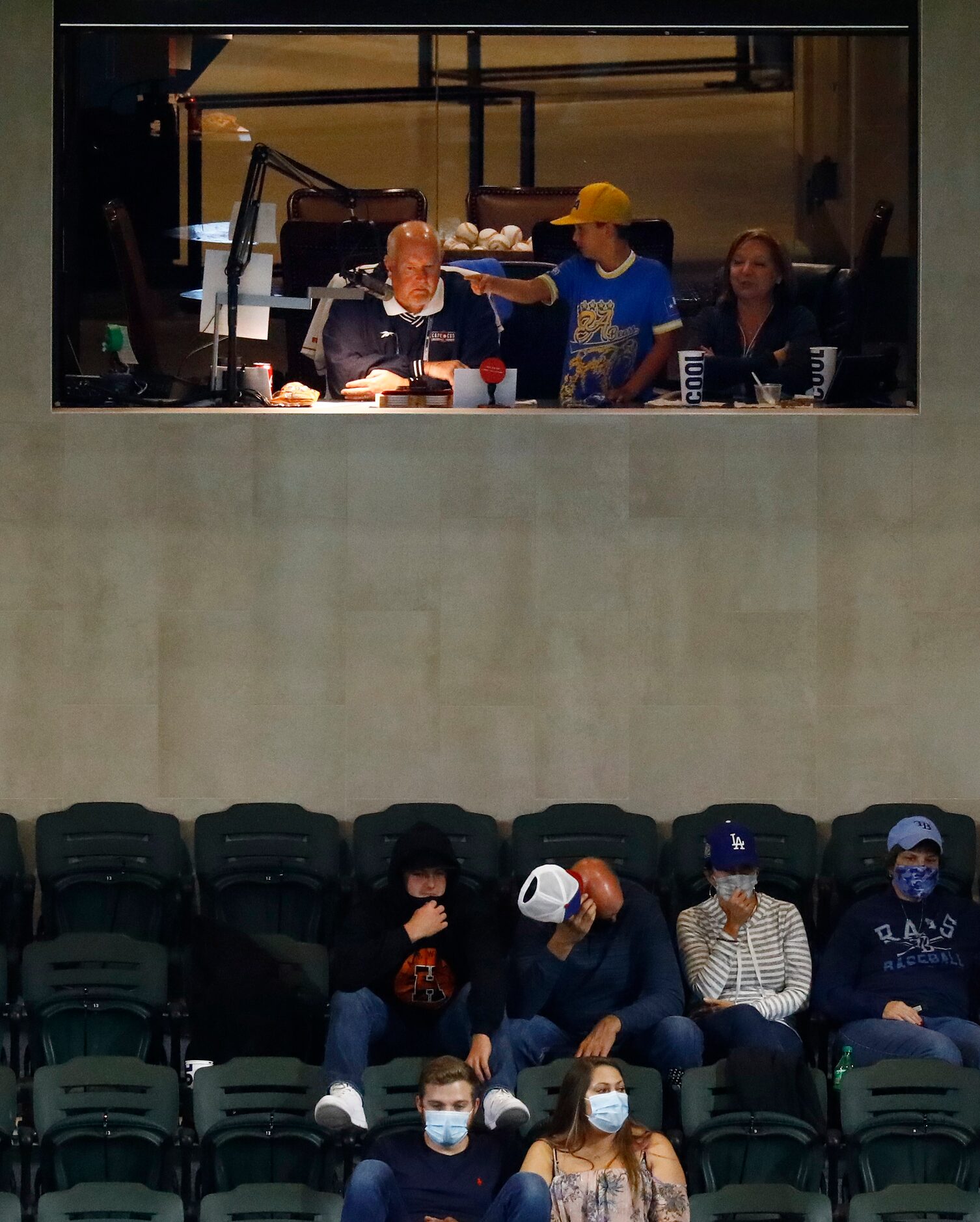 Public address announcer Chuck Morgan watches the game and introduces the players during...